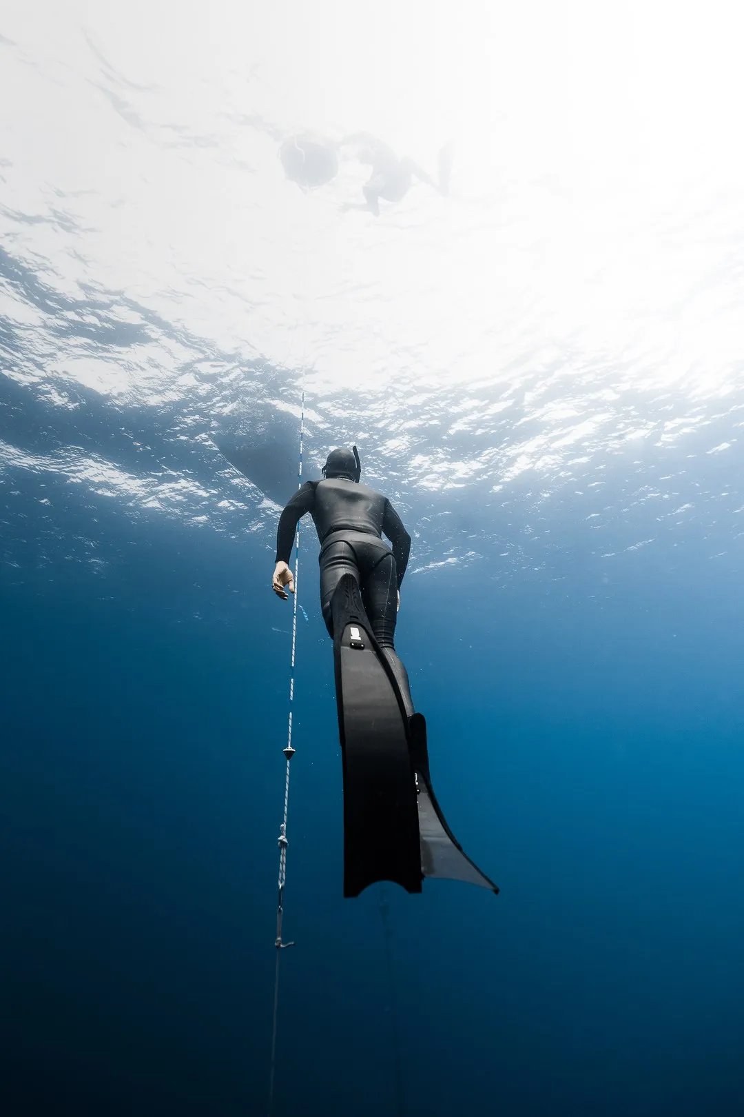 Advanced freediver free-falling on the line during AIDA 3 training off Oahu